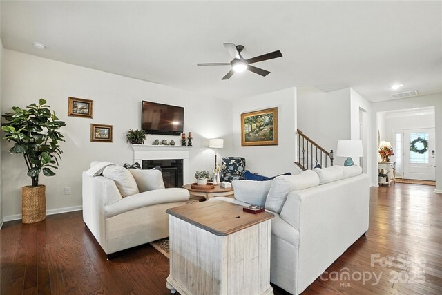 10120 Berkeley Castle Dr, Charlotte, NC 28273 - living room featuring ceiling fan, stairs, dark wood-type flooring, and a glass covered fireplace