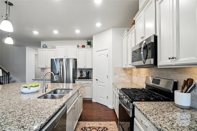 10120 Berkeley Castle Dr, Charlotte, NC 28273 - kitchen featuring stainless steel appliances, dark wood finished floors, white cabinets, pendant lighting, and recessed lighting