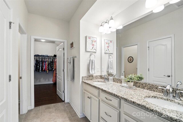 10120 Berkeley Castle Dr, Charlotte, NC 28273 - full bath featuring double vanity, tile patterned flooring, and a spacious closet