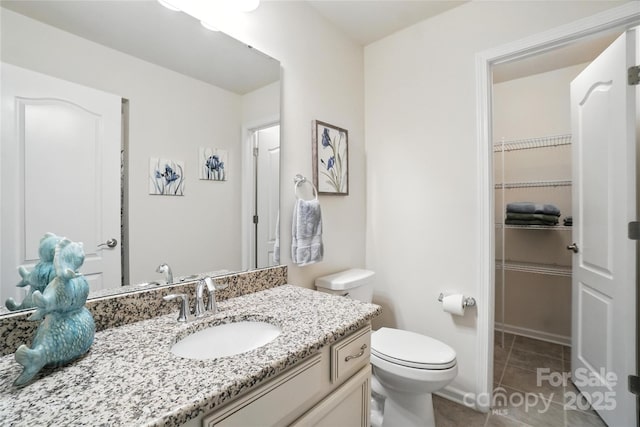 10120 Berkeley Castle Dr, Charlotte, NC 28273 - bathroom featuring vanity, tile patterned floors, and a spacious closet