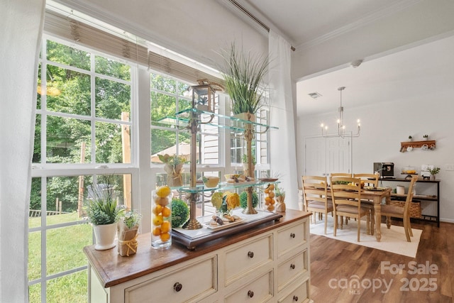 137 Branchview Dr, Mooresville, NC 28115 - kitchen with crown molding, a chandelier, dark wood-style floors, wooden counters, and pendant lighting