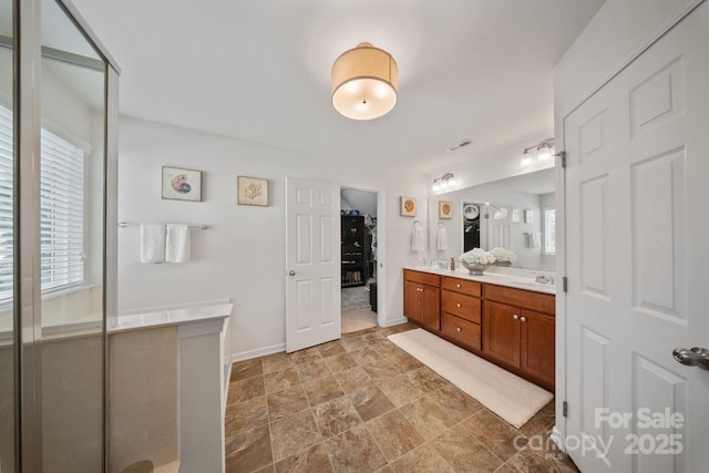 137 Branchview Dr, Mooresville, NC 28115 - bathroom with double vanity, plenty of natural light, stone finish flooring, and a walk in closet