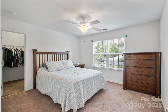 137 Branchview Dr, Mooresville, NC 28115 - bedroom with light colored carpet, a walk in closet, a closet, and ceiling fan