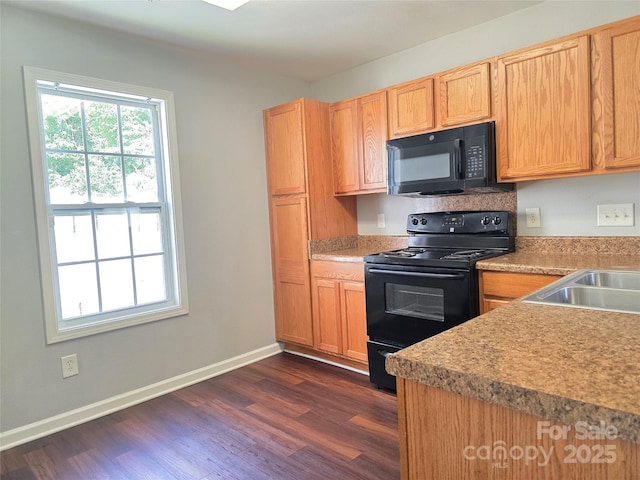 7315 Fig Ln, Charlotte, NC 28215 - kitchen with black appliances, dark wood-style flooring, and light countertops