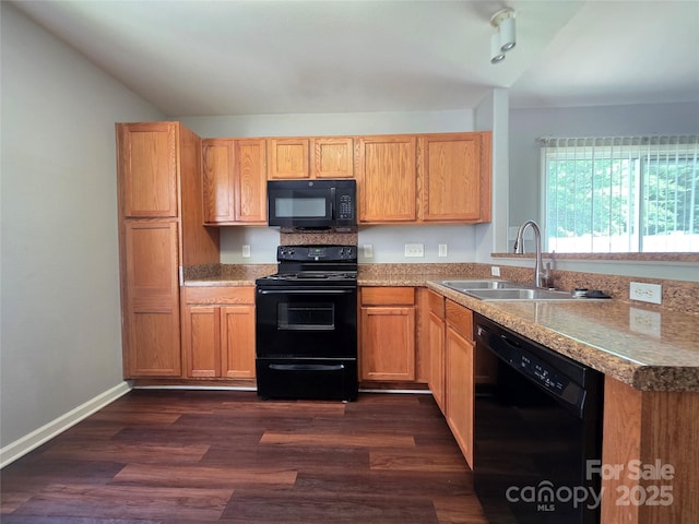 7315 Fig Ln, Charlotte, NC 28215 - kitchen with black appliances, vaulted ceiling, dark wood-type flooring, a peninsula, and light countertops