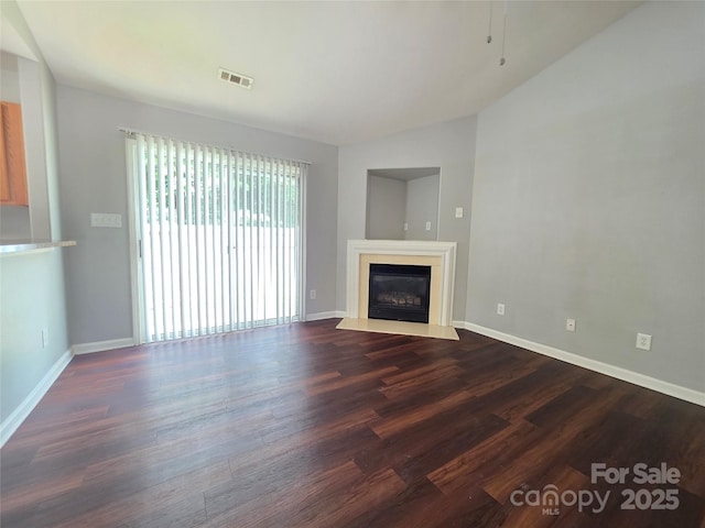7315 Fig Ln, Charlotte, NC 28215 - unfurnished living room featuring dark wood-type flooring and a glass covered fireplace