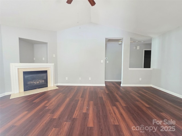 7315 Fig Ln, Charlotte, NC 28215 - unfurnished living room with a ceiling fan, lofted ceiling, dark wood-style flooring, and a glass covered fireplace