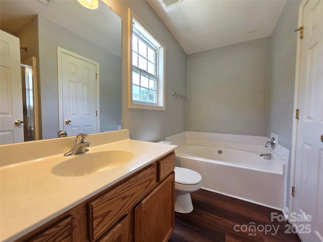 7315 Fig Ln, Charlotte, NC 28215 - bathroom featuring wood finished floors, a bath, and vanity