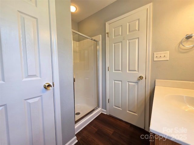 7315 Fig Ln, Charlotte, NC 28215 - full bathroom with a shower stall, wood finished floors, and vanity
