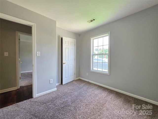 7315 Fig Ln, Charlotte, NC 28215 - unfurnished bedroom with carpet flooring and baseboards