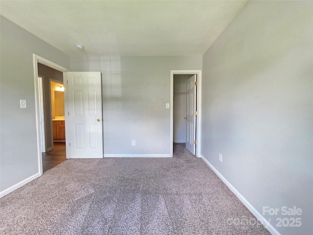 7315 Fig Ln, Charlotte, NC 28215 - unfurnished bedroom with carpet and a walk in closet