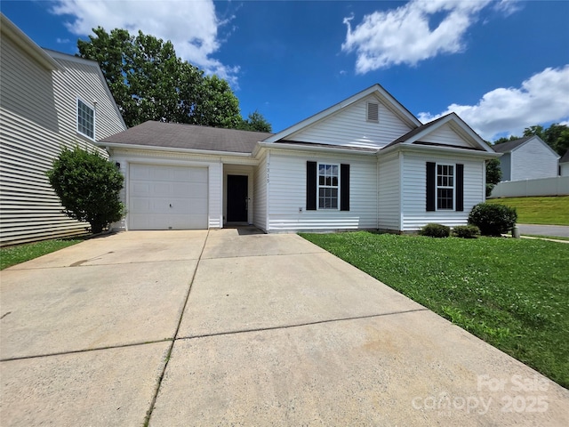 7315 Fig Ln, Charlotte, NC 28215 - view of front of house with an attached garage, concrete driveway, and a front yard