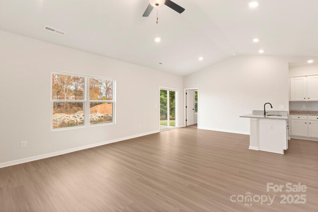 1047 Russell Dr, Winston Salem, NC 27127 - unfurnished living room featuring recessed lighting, light wood-type flooring, a ceiling fan, and vaulted ceiling