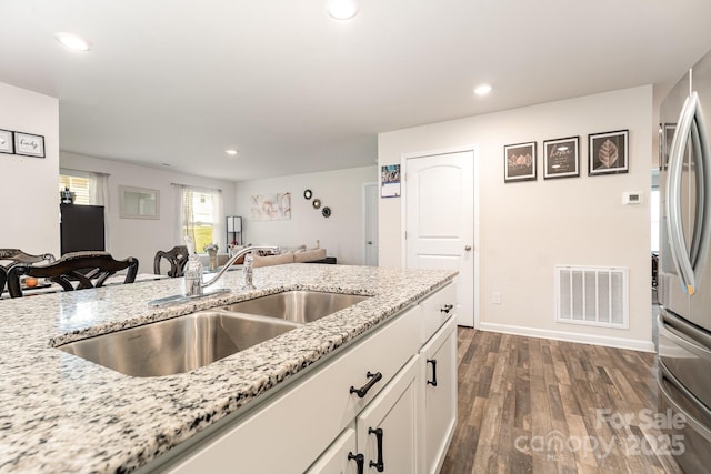 418 Winsley Dr, Salisbury, NC 28147 - kitchen with white cabinetry, dark wood-style flooring, recessed lighting, freestanding refrigerator, and light stone counters