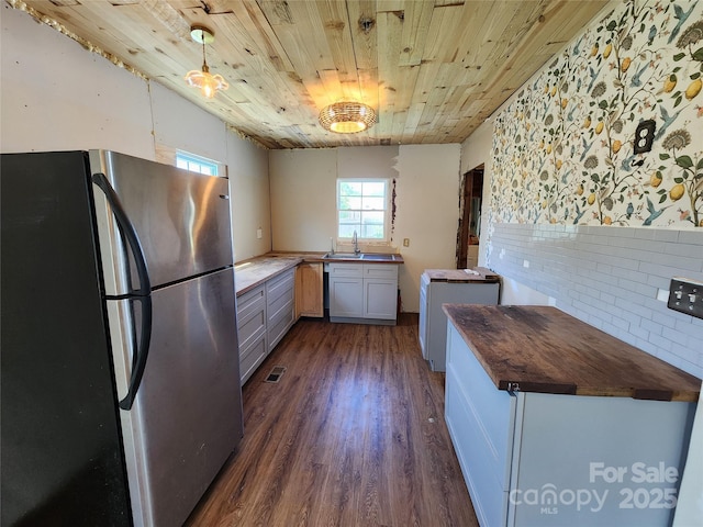 1004 S Ridge Ave, Kannapolis, NC 28083 - kitchen featuring freestanding refrigerator, wood ceiling, dark wood-style flooring, washer / dryer, and wood counters