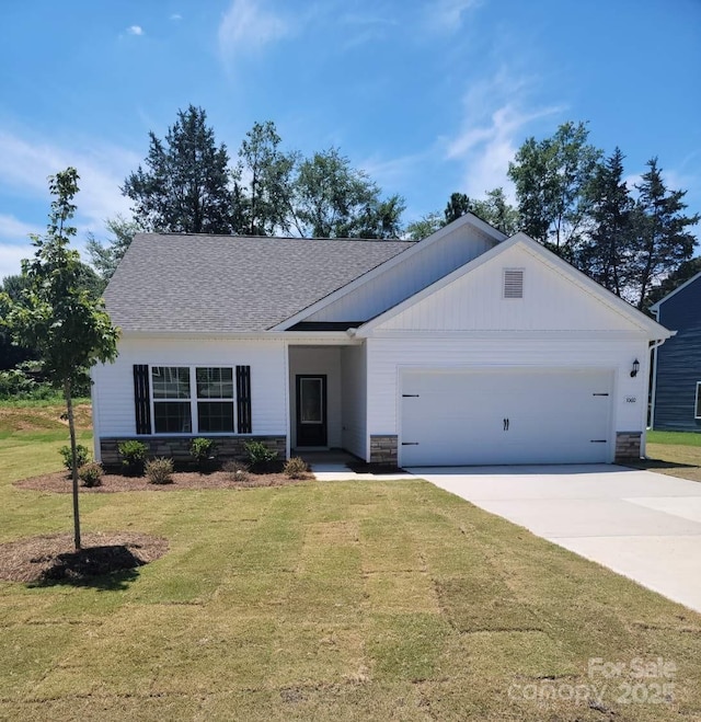 1060 Russell Dr, Winston Salem, NC 27127 - view of front of house featuring a garage, a front yard, concrete driveway, roof with shingles, and stone siding