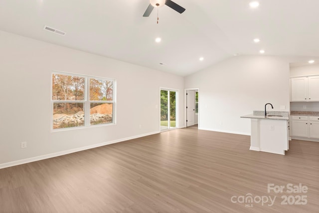 1060 Russell Dr, Winston Salem, NC 27127 - unfurnished living room featuring recessed lighting, light wood-type flooring, a ceiling fan, and vaulted ceiling