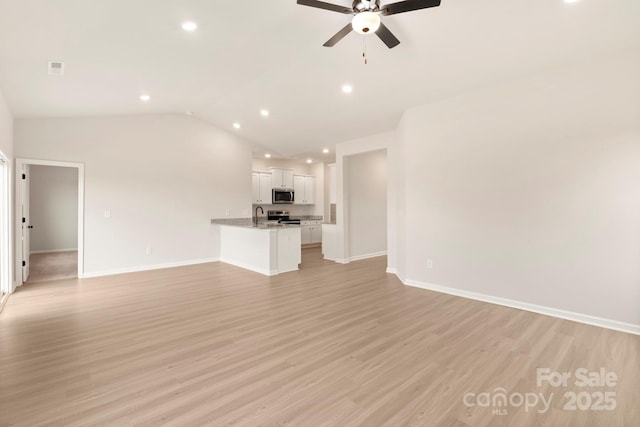 1060 Russell Dr, Winston Salem, NC 27127 - unfurnished living room featuring a ceiling fan, recessed lighting, light wood finished floors, and vaulted ceiling