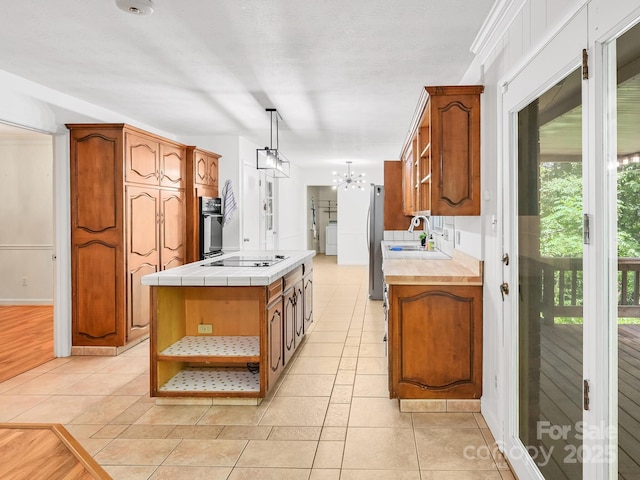 8 Mayfair Dr, Candler, NC 28715 - kitchen featuring black appliances, open shelves, a chandelier, tile counters, and light tile patterned floors