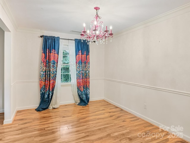 8 Mayfair Dr, Candler, NC 28715 - unfurnished room with a chandelier, light wood-style floors, and ornamental molding