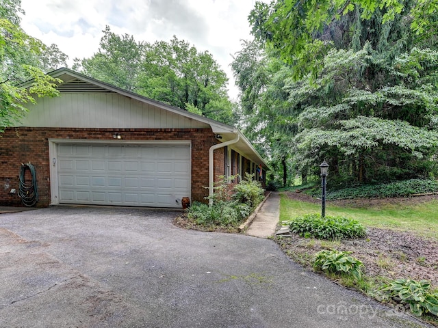 8 Mayfair Dr, Candler, NC 28715 - view of side of property with brick siding, asphalt driveway, and an attached garage