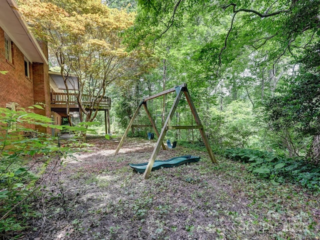 8 Mayfair Dr, Candler, NC 28715 - view of yard with a playground, a view of trees, and a wooden deck