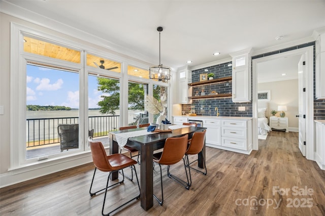 5985 Natoma Rd, Clover, SC 29710 - dining space with wood finished floors, a water view, a chandelier, recessed lighting, and crown molding
