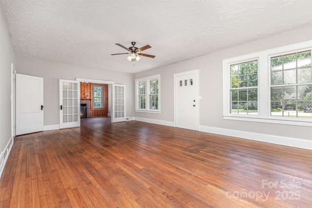 309 E Main St, Lattimore, NC 28089 - unfurnished living room with ceiling fan, hardwood / wood-style flooring, a textured ceiling, and french doors