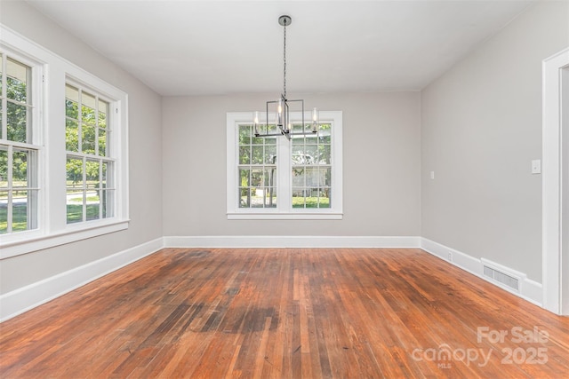 309 E Main St, Lattimore, NC 28089 - unfurnished dining area featuring a chandelier and hardwood / wood-style floors