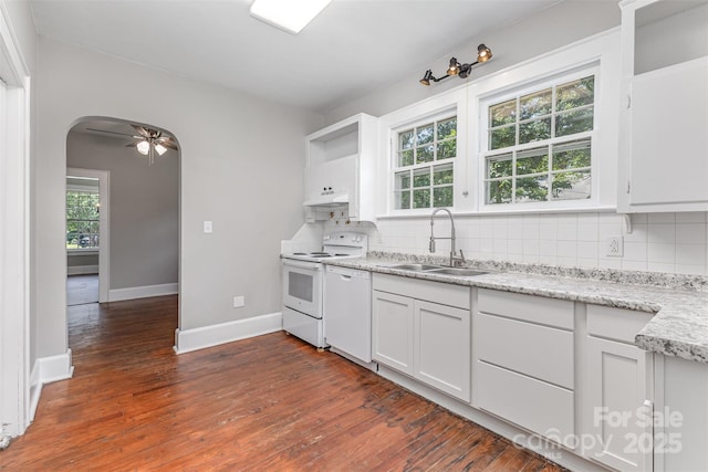 309 E Main St, Lattimore, NC 28089 - kitchen featuring white appliances, arched walkways, backsplash, dark wood-style flooring, and under cabinet range hood