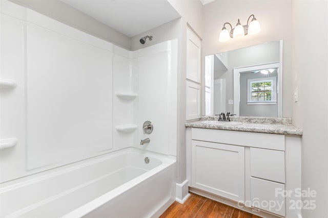 309 E Main St, Lattimore, NC 28089 - full bath featuring shower / bathtub combination, vanity, and wood finished floors