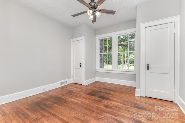 309 E Main St, Lattimore, NC 28089 - unfurnished room featuring wood finished floors, ceiling fan, and a textured ceiling