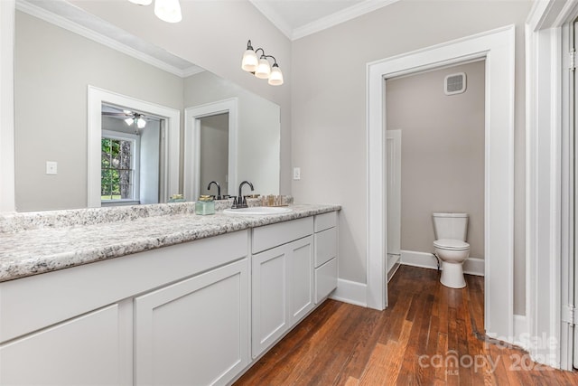 309 E Main St, Lattimore, NC 28089 - bathroom featuring crown molding, vanity, wood finished floors, and a ceiling fan