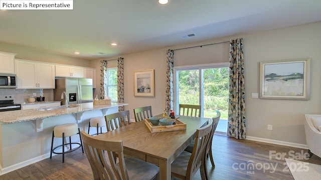 1400 Secrest Commons Dr, Monroe, NC 28112 - dining area with healthy amount of natural light, dark wood-style flooring, and recessed lighting