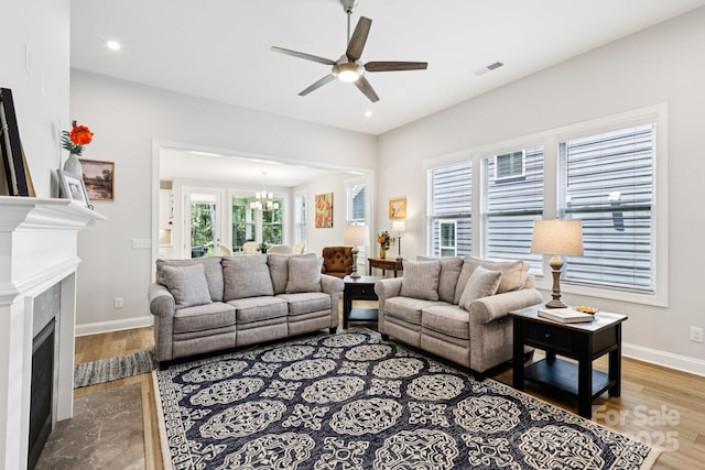 3022 Trace Meadow Ct, York, SC 29745 - living area featuring ceiling fan, wood finished floors, a fireplace with flush hearth, a chandelier, and recessed lighting