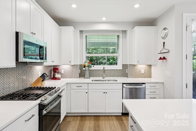 3022 Trace Meadow Ct, York, SC 29745 - kitchen with stainless steel appliances, light wood-style flooring, light countertops, white cabinetry, and recessed lighting