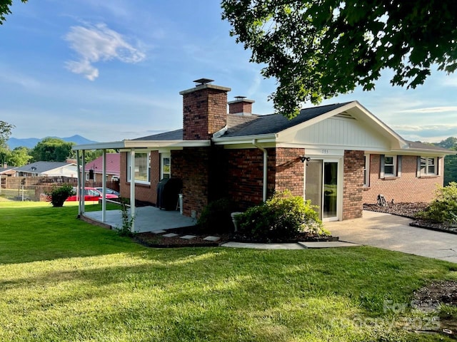 795 Monte Vista Rd, Candler, NC 28715 - back of house featuring a patio area, a chimney, brick siding, and a mountain view