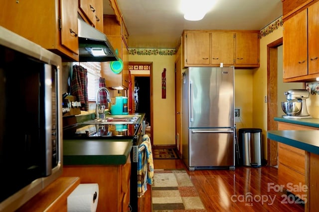 795 Monte Vista Rd, Candler, NC 28715 - kitchen featuring freestanding refrigerator, under cabinet range hood, range with electric stovetop, dark wood-type flooring, and refrigerator