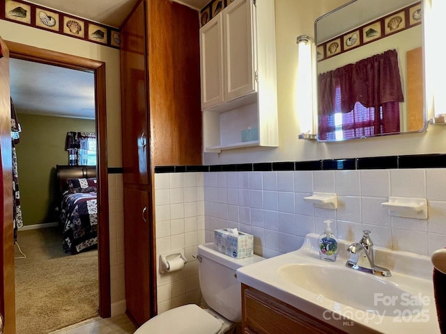 795 Monte Vista Rd, Candler, NC 28715 - ensuite bathroom with vanity, a wainscoted wall, and tile walls