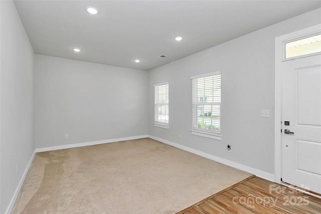 7079 Waterwheel St SW, Concord, NC 28025 - entrance foyer featuring recessed lighting, light colored carpet, and light wood finished floors