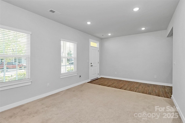 7079 Waterwheel St SW, Concord, NC 28025 - spare room with healthy amount of natural light, dark carpet, and recessed lighting