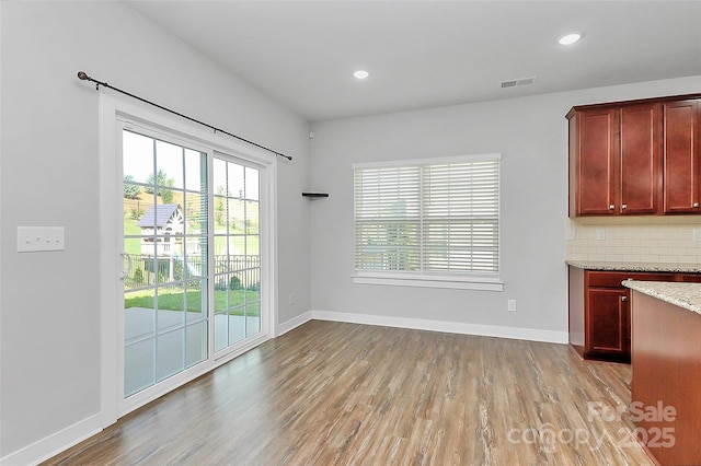 7079 Waterwheel St SW, Concord, NC 28025 - unfurnished dining area with light wood finished floors and recessed lighting