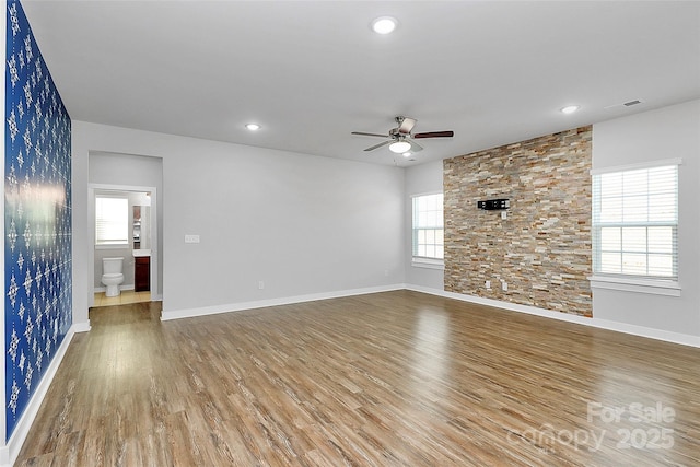 7079 Waterwheel St SW, Concord, NC 28025 - unfurnished living room with ceiling fan, wood finished floors, and recessed lighting