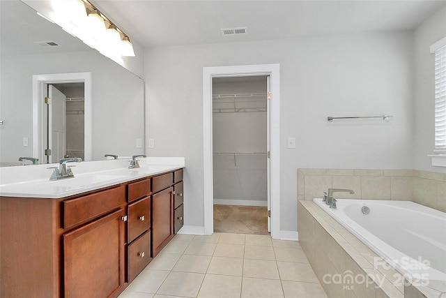 7079 Waterwheel St SW, Concord, NC 28025 - full bathroom with double vanity, a bath, tile patterned floors, and a spacious closet