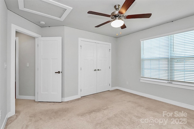 7079 Waterwheel St SW, Concord, NC 28025 - unfurnished bedroom with light colored carpet, attic access, ceiling fan, and a closet