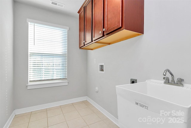 7079 Waterwheel St SW, Concord, NC 28025 - washroom featuring hookup for a washing machine, cabinet space, electric dryer hookup, and light tile patterned floors
