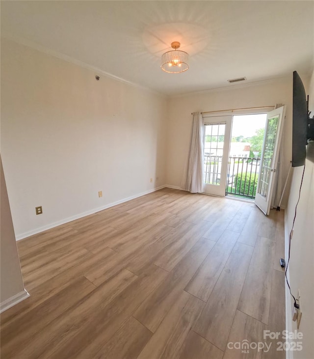 1410 4th Street Dr NW Unit 303, Hickory, NC 28601 - unfurnished room featuring wood finished floors, a chandelier, and crown molding