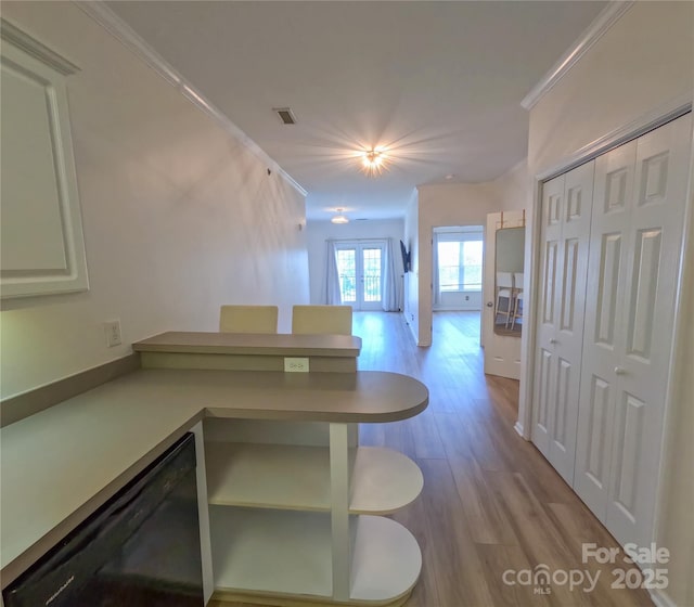 1410 4th Street Dr NW Unit 303, Hickory, NC 28601 - unfurnished dining area featuring french doors, wood finished floors, and ornamental molding