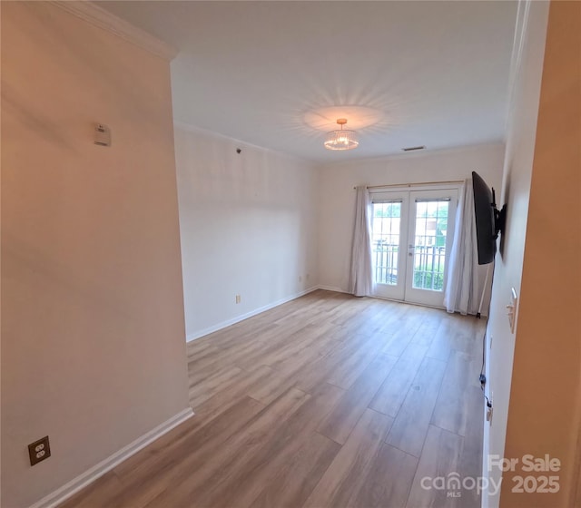 1410 4th Street Dr NW Unit 303, Hickory, NC 28601 - empty room featuring ornamental molding, wood finished floors, and french doors