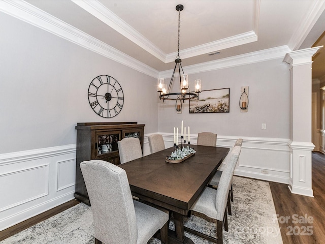 2005 Arbor Hills Dr, Indian Trail, NC 28079 - dining area with ornate columns, dark wood-type flooring, a raised ceiling, a chandelier, and ornamental molding